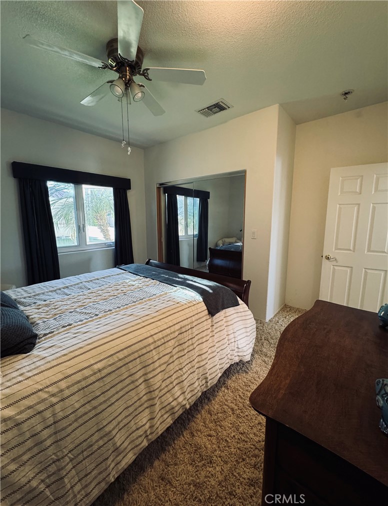 5770 Colorado River Road Blythe, CA 92225 - Photo 15 of 34 a bedroom with a bed and a chandelier