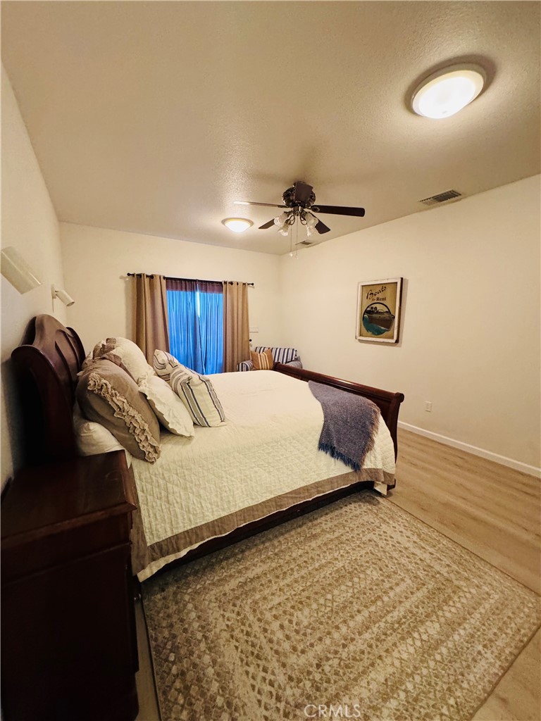 5770 Colorado River Road Blythe, CA 92225 - Photo 19 of 34 a bedroom with a bed and ceiling fan