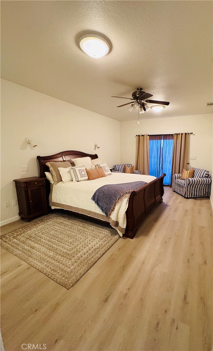 5770 Colorado River Road Blythe, CA 92225 - Photo 20 of 34 a spacious bedroom with a bed and a ceiling fan