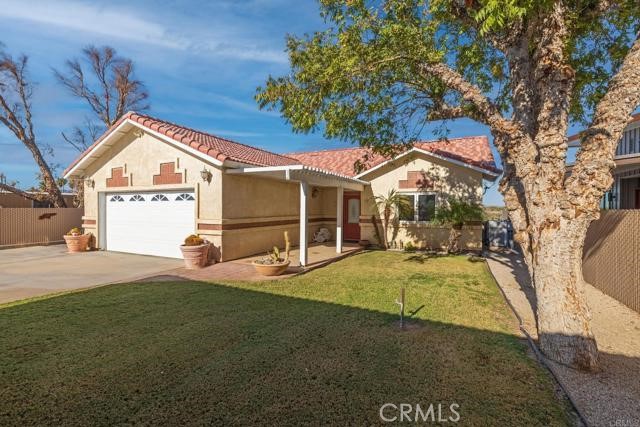5770 Colorado River Road Blythe, CA 92225 - Photo 2 of 34 a front view of a house with a yard and garage