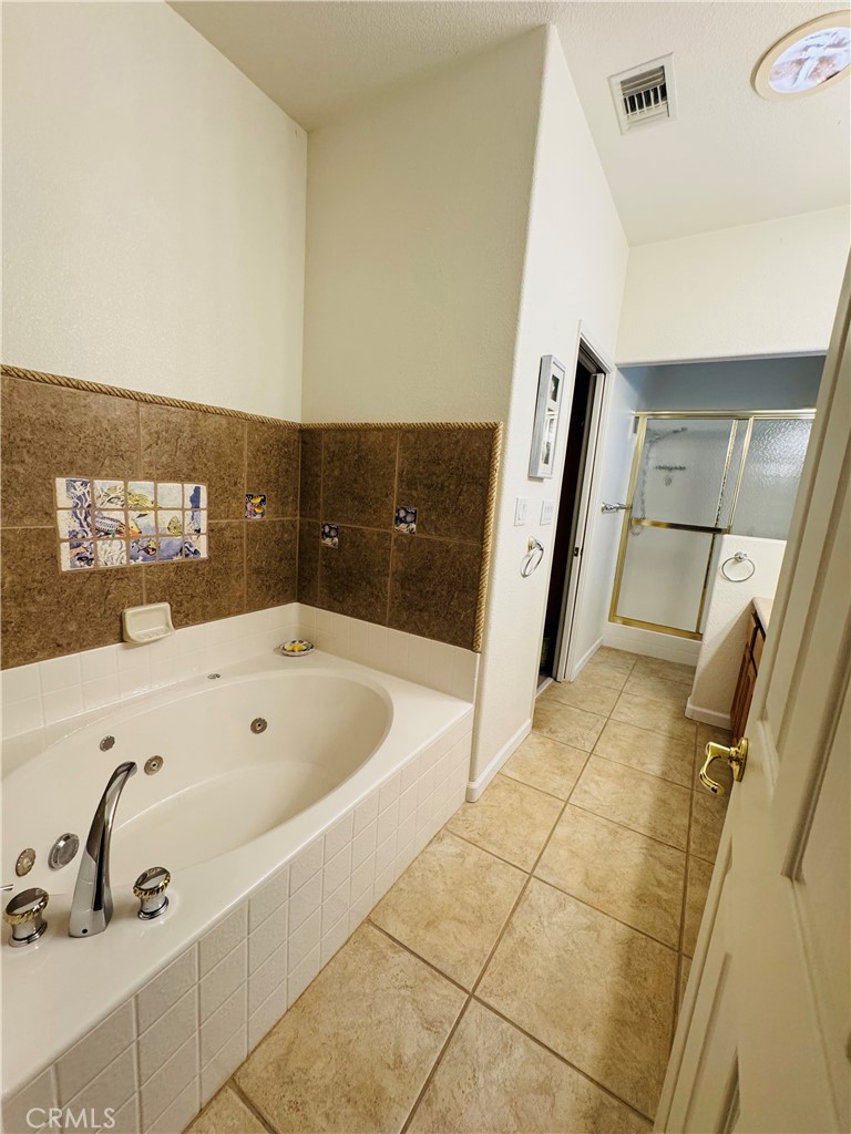 5770 Colorado River Road Blythe, CA 92225 - Photo 21 of 34 a bathroom with a bathtub and shower