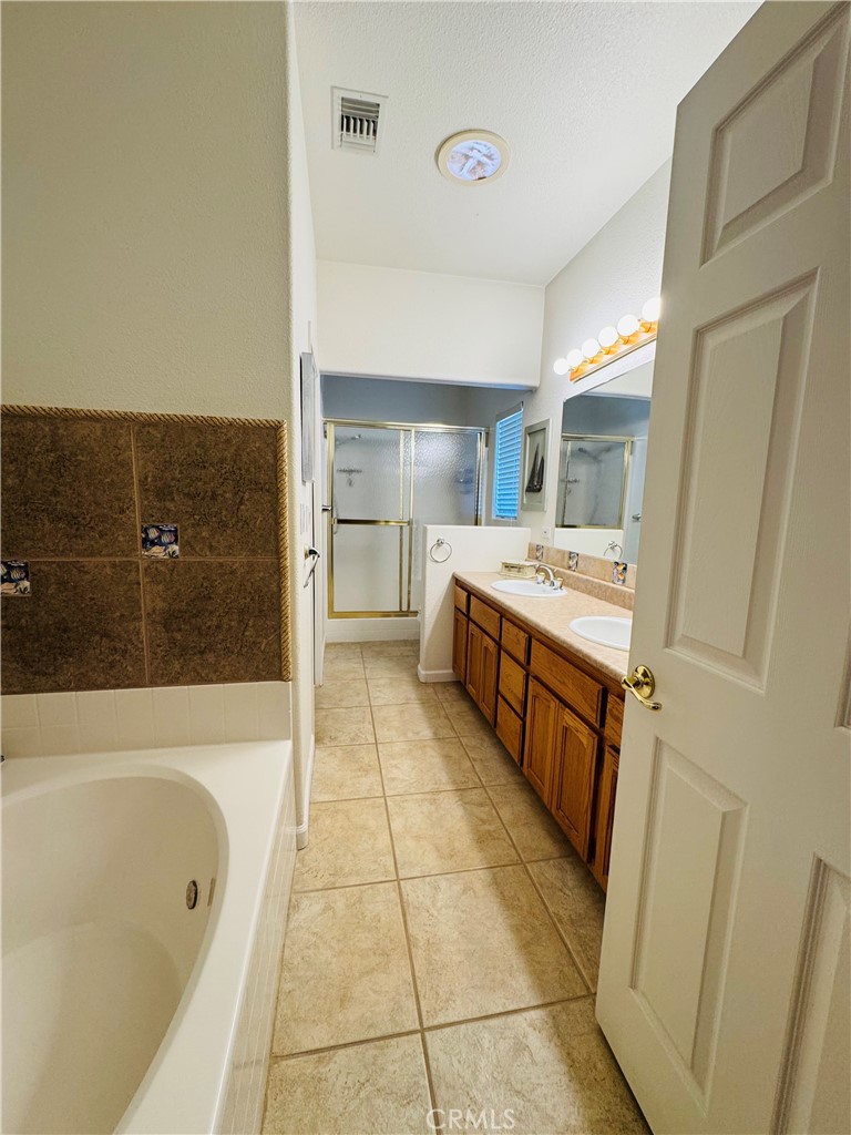 5770 Colorado River Road Blythe, CA 92225 - Photo 22 of 34 a spacious bathroom with a tub sink and mirror