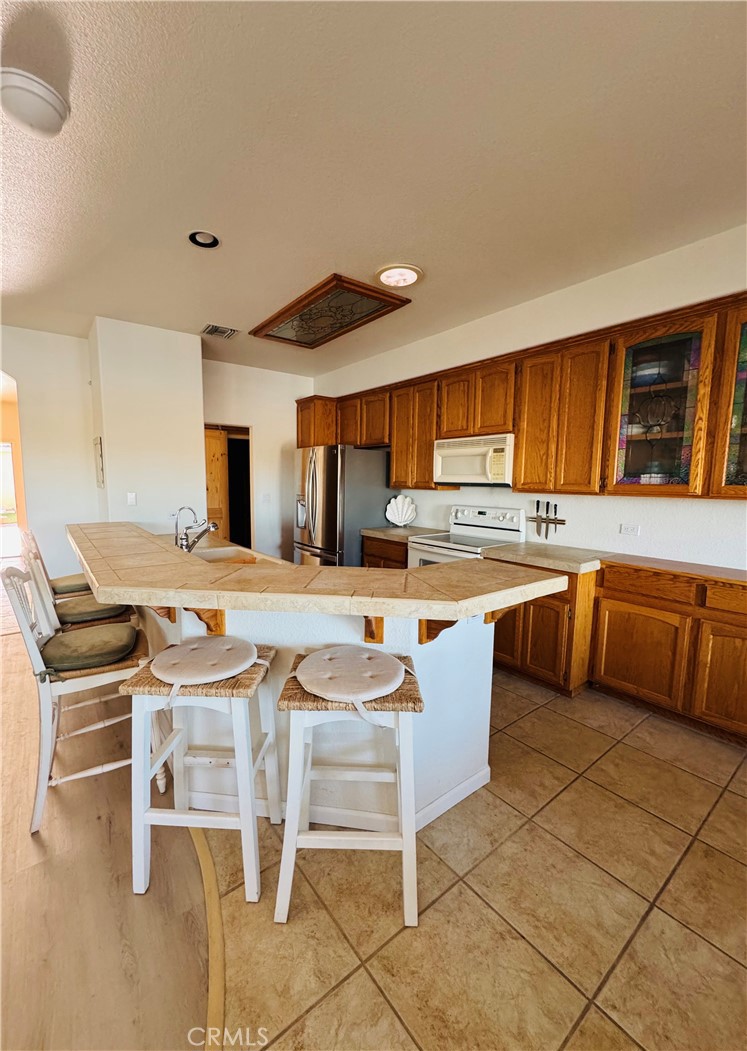 5770 Colorado River Road Blythe, CA 92225 - Photo 5 of 34 a kitchen with stainless steel appliances kitchen island granite countertop a sink and cabinets
