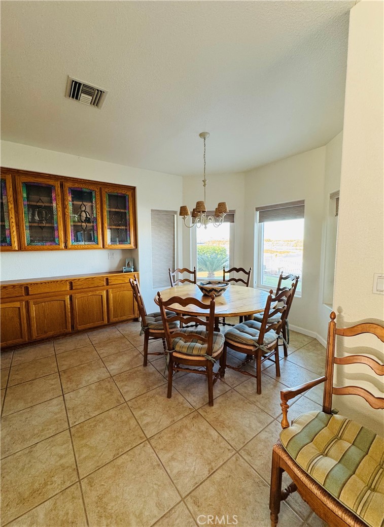 5770 Colorado River Road Blythe, CA 92225 - Photo 6 of 34 a bedroom with furniture and a chandelier
