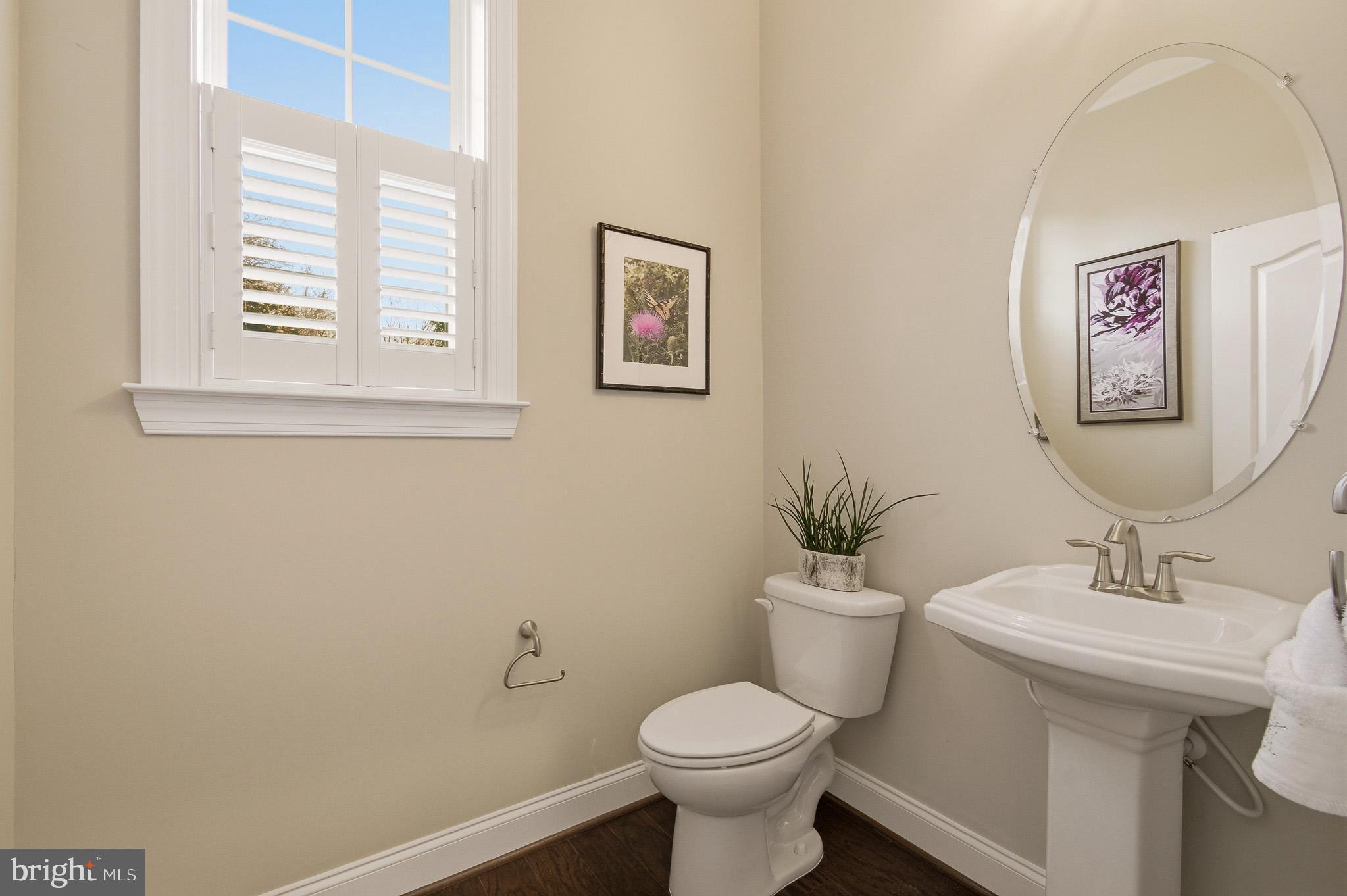 805 Lower Barn Way Olney, MD 20832 - Photo 12 of 77 a bathroom with a toilet sink and mirror
