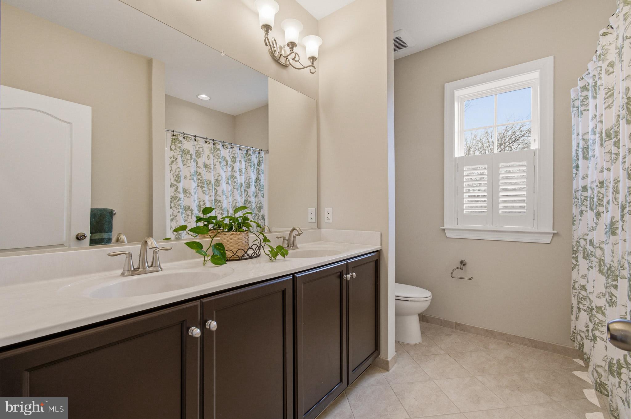 805 Lower Barn Way Olney, MD 20832 - Photo 52 of 77 a bathroom with a sink a toilet and a mirror