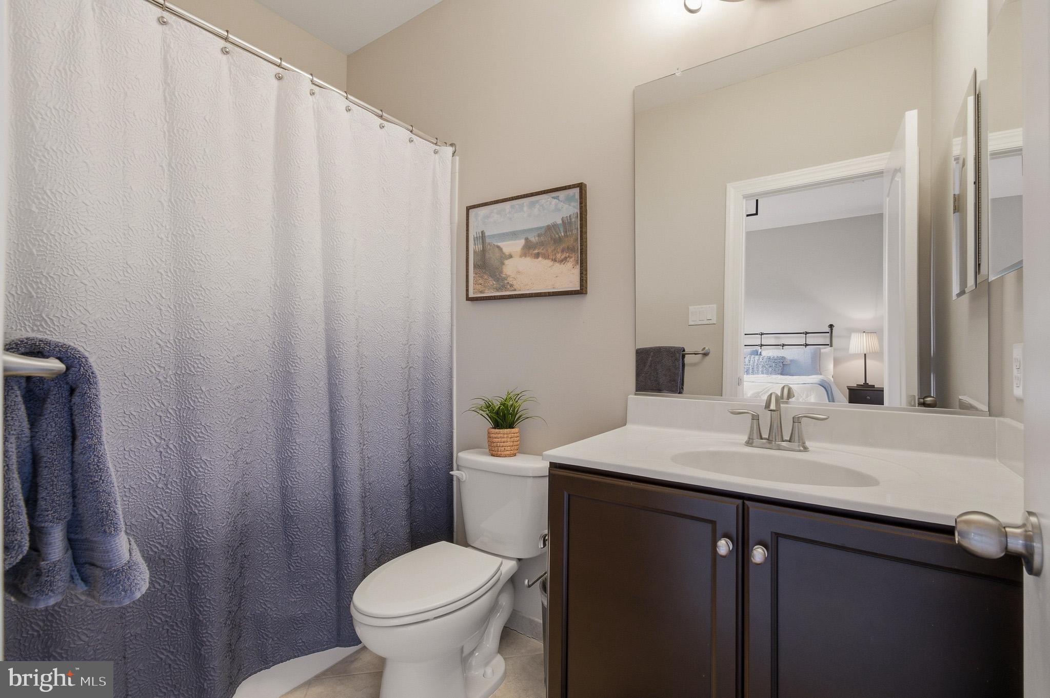 805 Lower Barn Way Olney, MD 20832 - Photo 56 of 77 a bathroom with a sink a toilet and a mirror