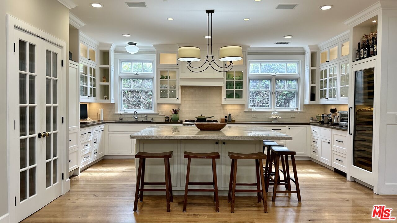 910 Marco Place Venice, CA 90291 - Photo 12 of 43 a kitchen with stainless steel appliances granite countertop a table chairs stove and refrigerator