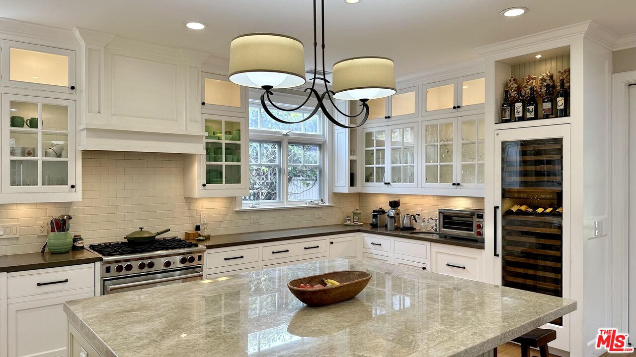 910 Marco Place Venice, CA 90291 - Photo 13 of 43 a kitchen with stainless steel appliances granite countertop a stove a sink and a white cabinets
