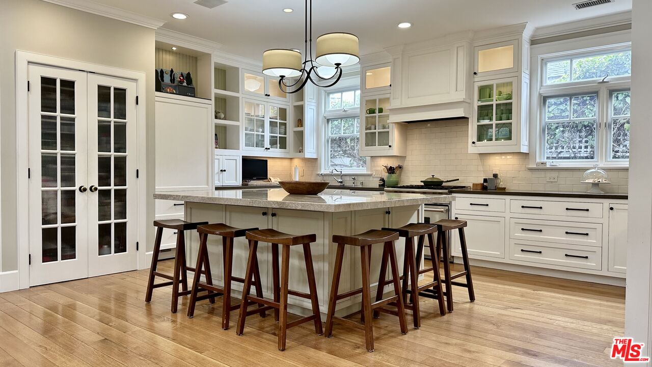 910 Marco Place Venice, CA 90291 - Photo 14 of 43 a kitchen with granite countertop a table chairs stove and a granite counter tops