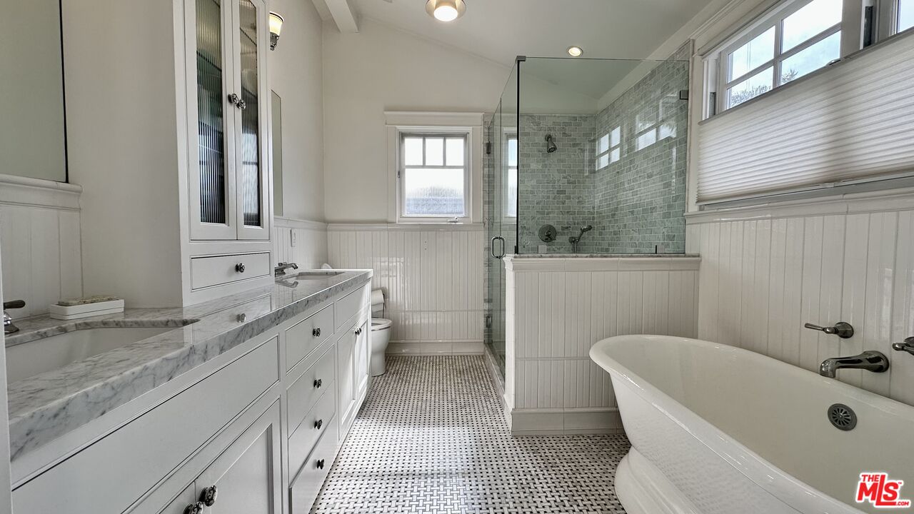 910 Marco Place Venice, CA 90291 - Photo 21 of 43 a bathroom with a granite countertop tub sink and mirror