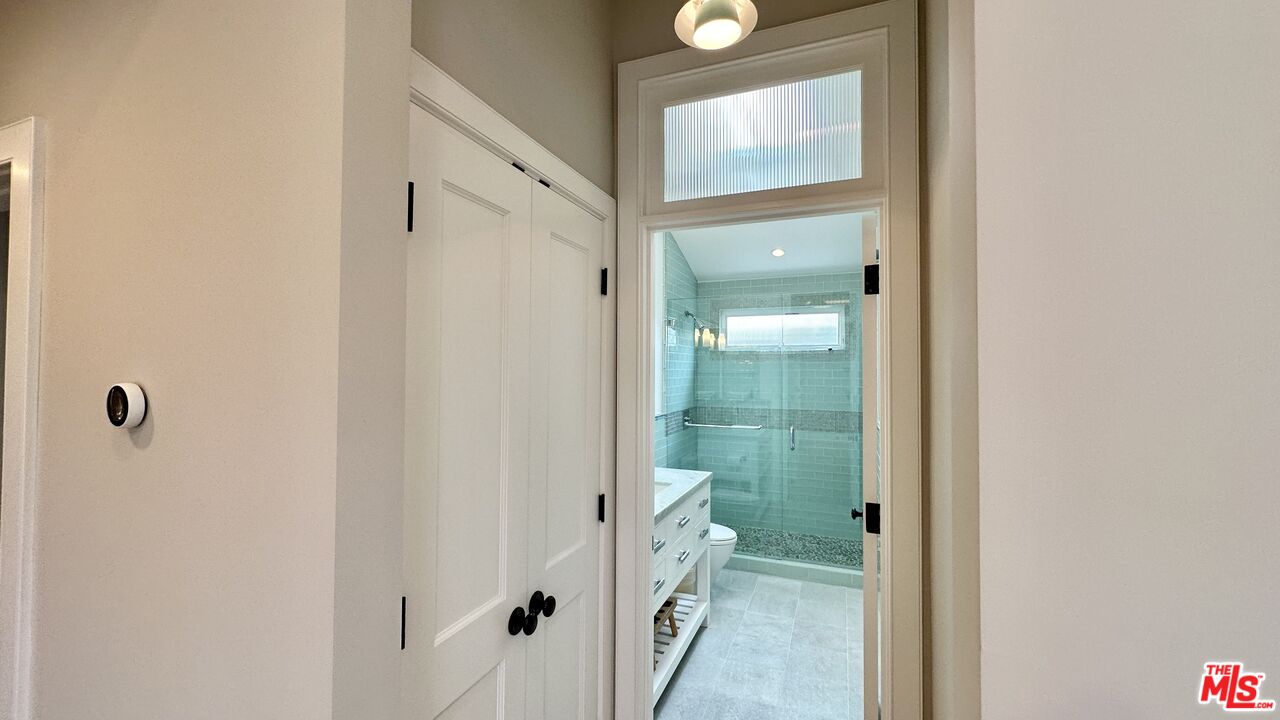 910 Marco Place Venice, CA 90291 - Photo 30 of 43 a bathroom with a glass shower door