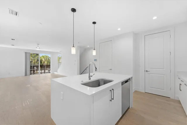 a kitchen with a sink and chandelier