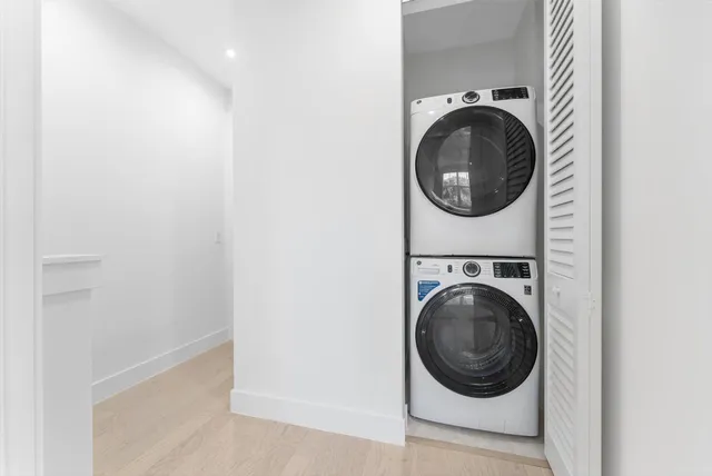a view of a hallway with washer and dryer