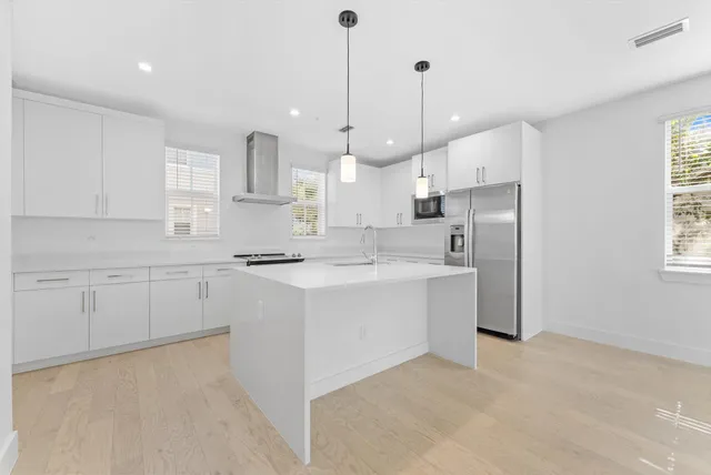 a kitchen with white cabinets and white appliances