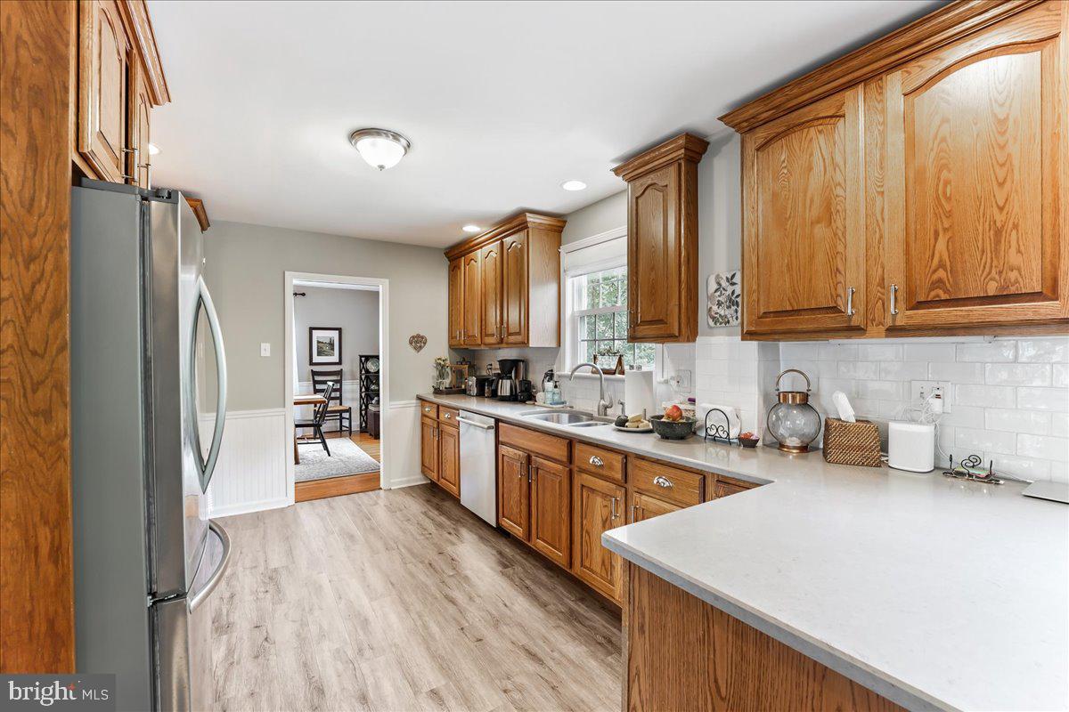 400 Southcroft Road Springfield, PA 19064 - Photo 12 of 44 a kitchen with stainless steel appliances a refrigerator sink and wooden cabinets
