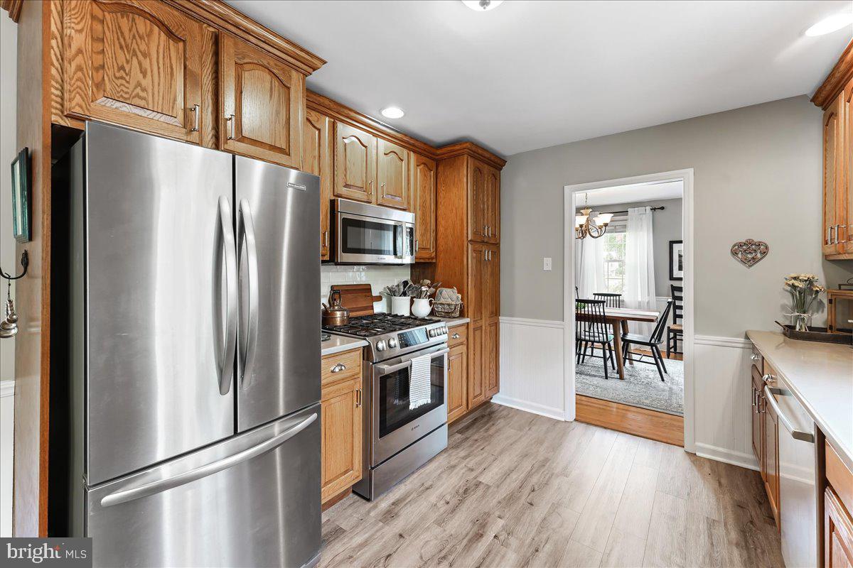 400 Southcroft Road Springfield, PA 19064 - Photo 13 of 44 a kitchen with stainless steel appliances granite countertop a refrigerator microwave and stove top oven