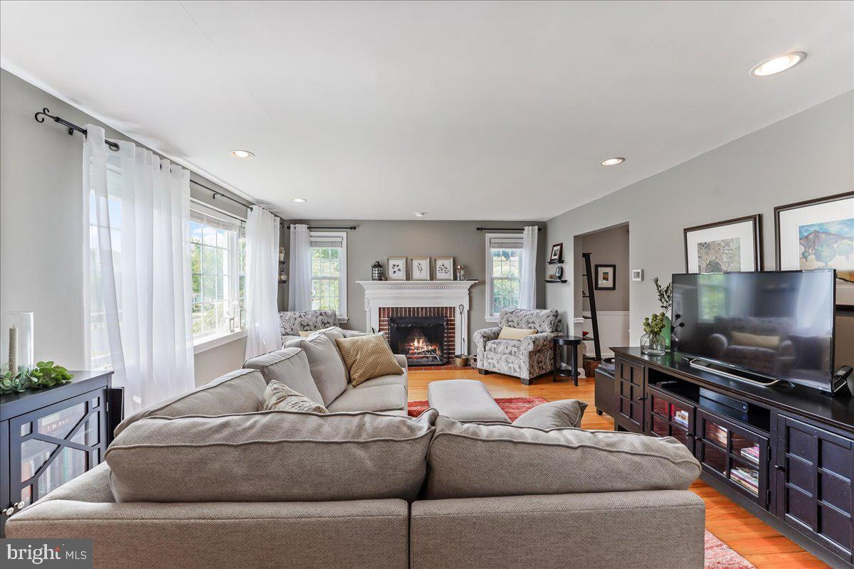 400 Southcroft Road Springfield, PA 19064 - Photo 5 of 44 a living room with furniture a flat screen tv and a fireplace