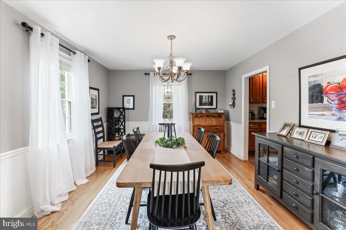 400 Southcroft Road Springfield, PA 19064 - Photo 10 of 44 a view of a dining room with furniture a chandelier and wooden floor