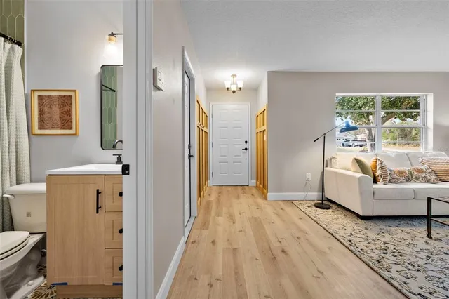 a kitchen with cabinets a sink and a wooden floor