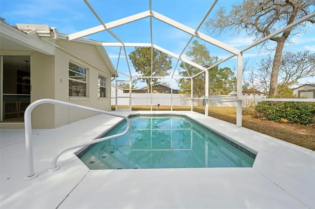 a view of a swimming pool with a patio