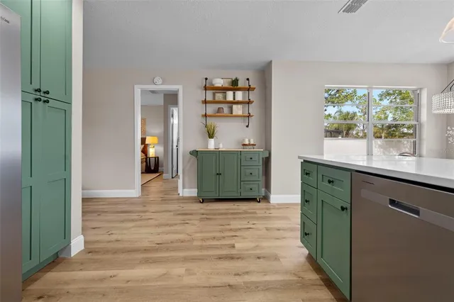 a view of a swimming pool with a yard and potted plants