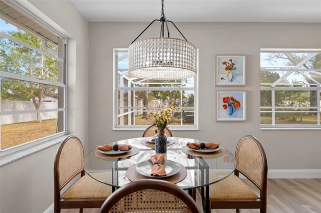 a kitchen with a dining table chairs and cabinets