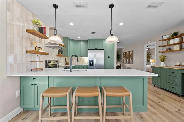 a bedroom with a large bed and a chandelier