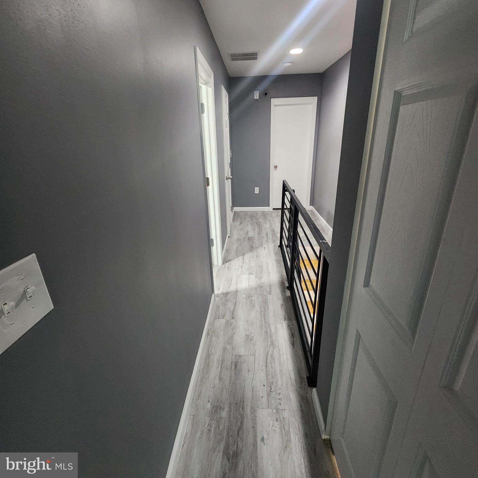 1926 East 28th Street Baltimore, MD 21218 - Photo 11 of 19 a view of a hallway with wooden floor and staircase