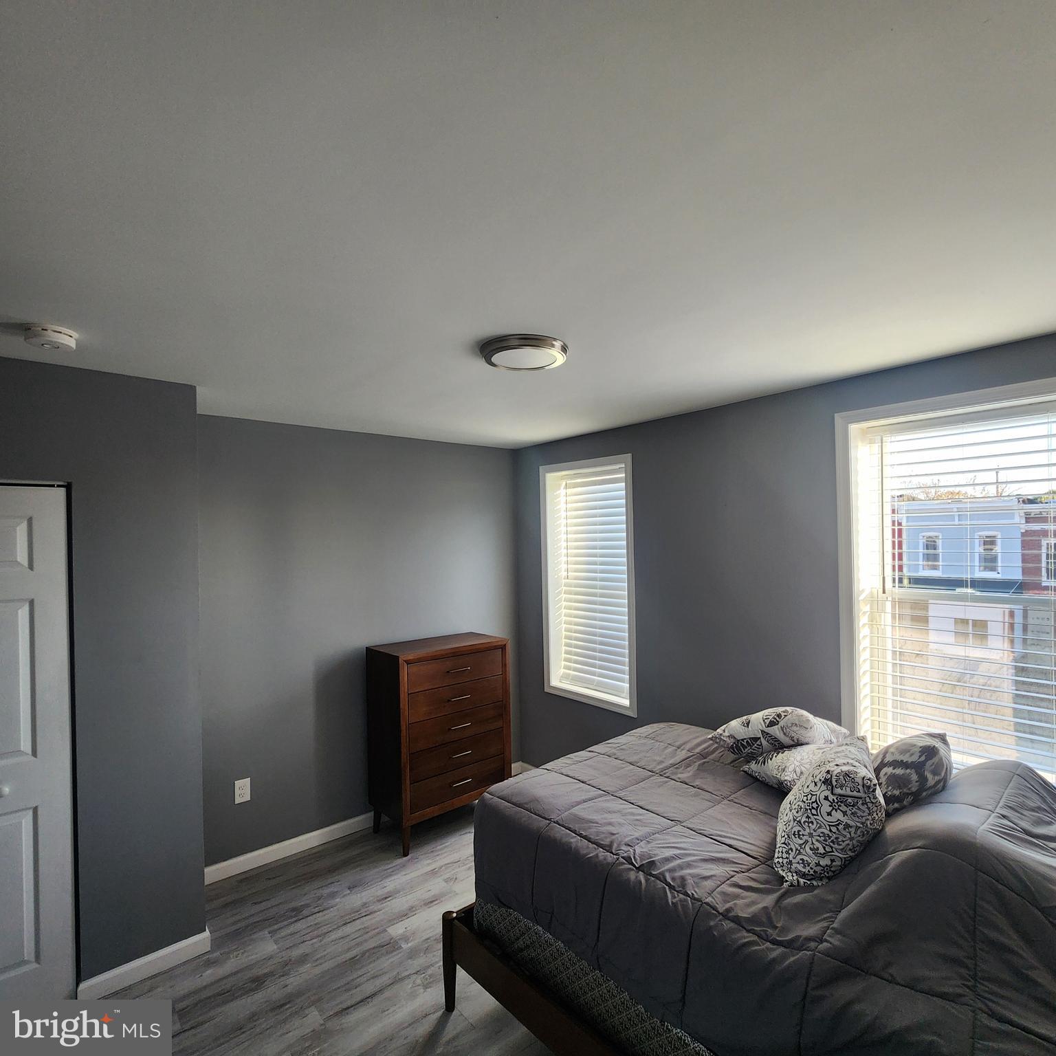 1926 East 28th Street Baltimore, MD 21218 - Photo 14 of 19 a bedroom with a bed and a window