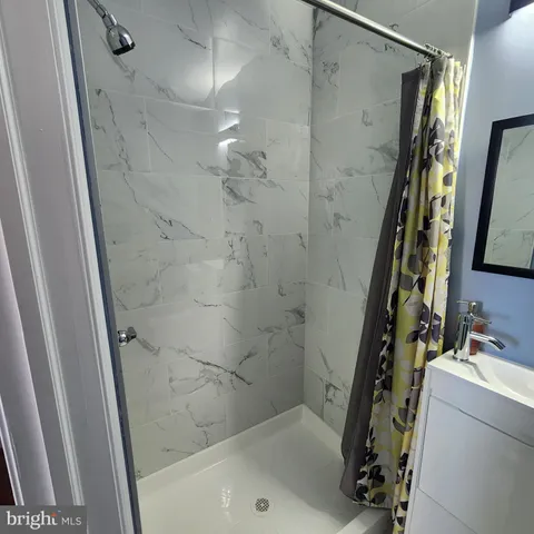 a bathroom with a toilet and a mirror