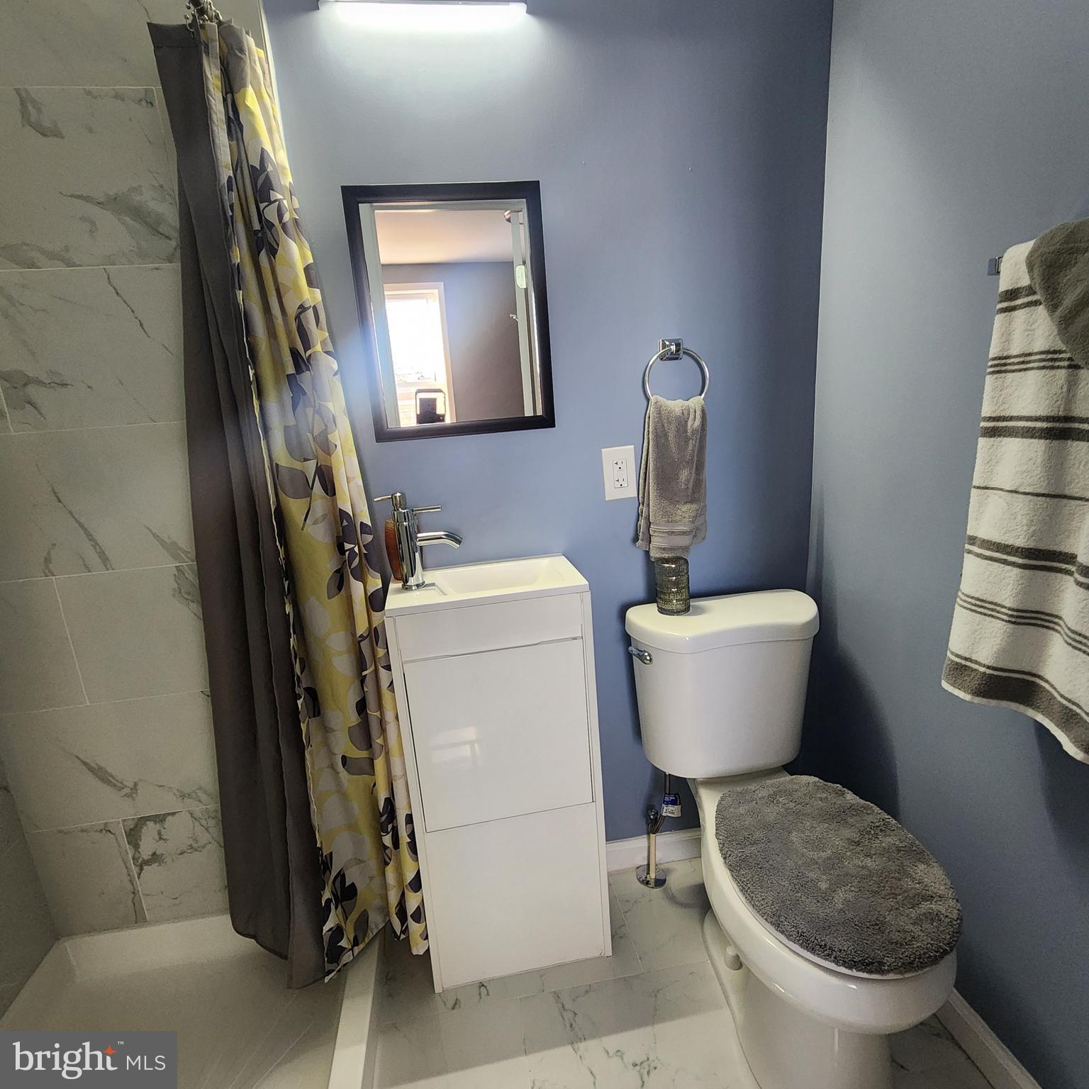1926 East 28th Street Baltimore, MD 21218 - Photo 16 of 19 a bathroom with a toilet and a mirror