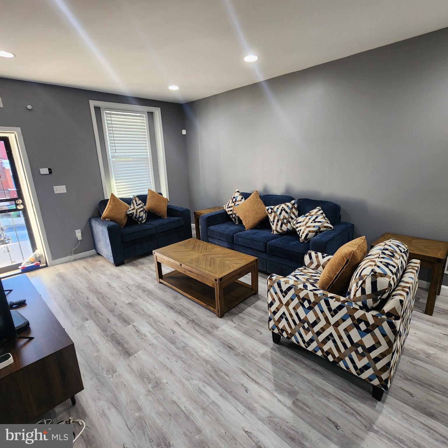 1926 East 28th Street Baltimore, MD 21218 - Photo 4 of 19 a living room with furniture and wooden floor