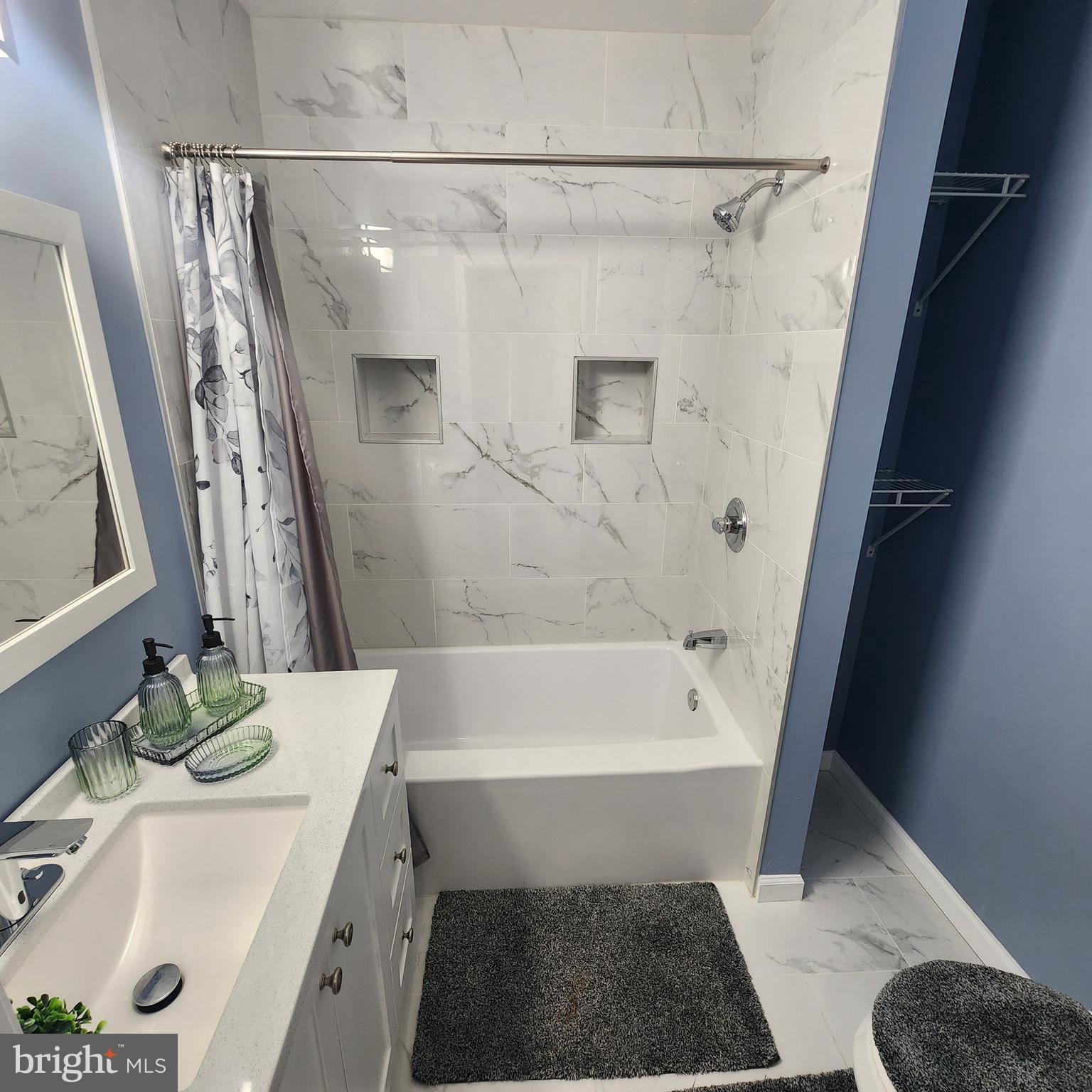 1926 East 28th Street Baltimore, MD 21218 - Photo 10 of 19 a bathroom with a tub a sink and a shower