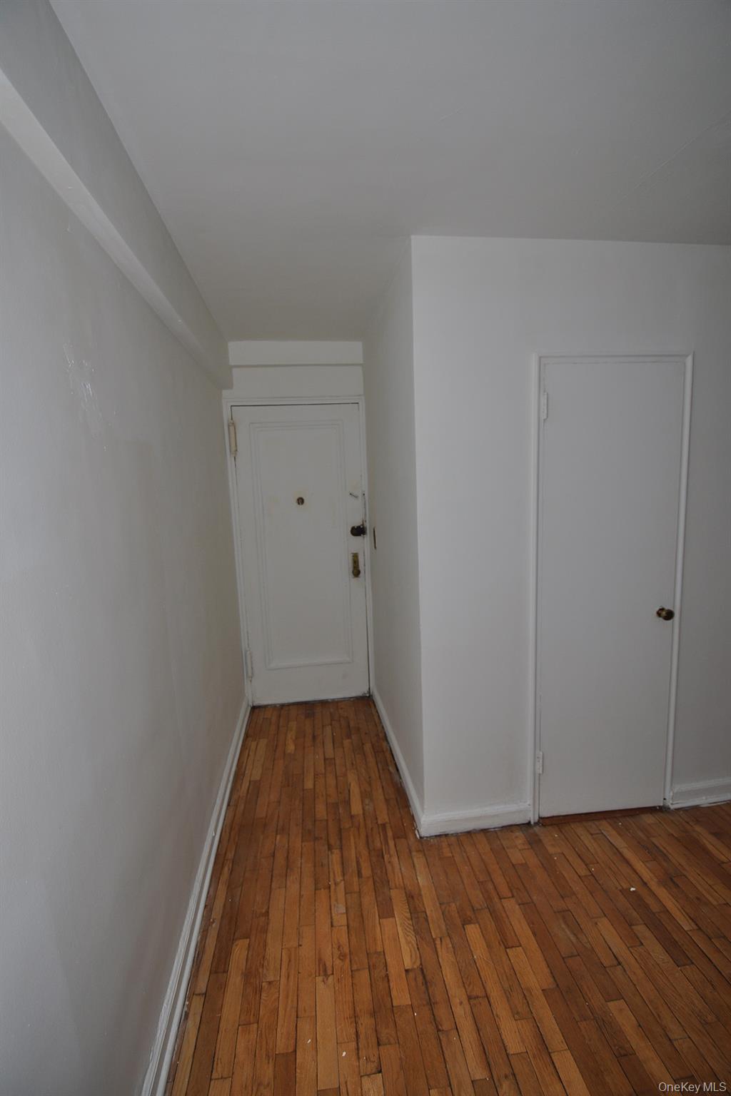 142 Garth Road, Unit 1R Scarsdale, NY 10583 - Photo 3 of 12 wooden floor in a empty room