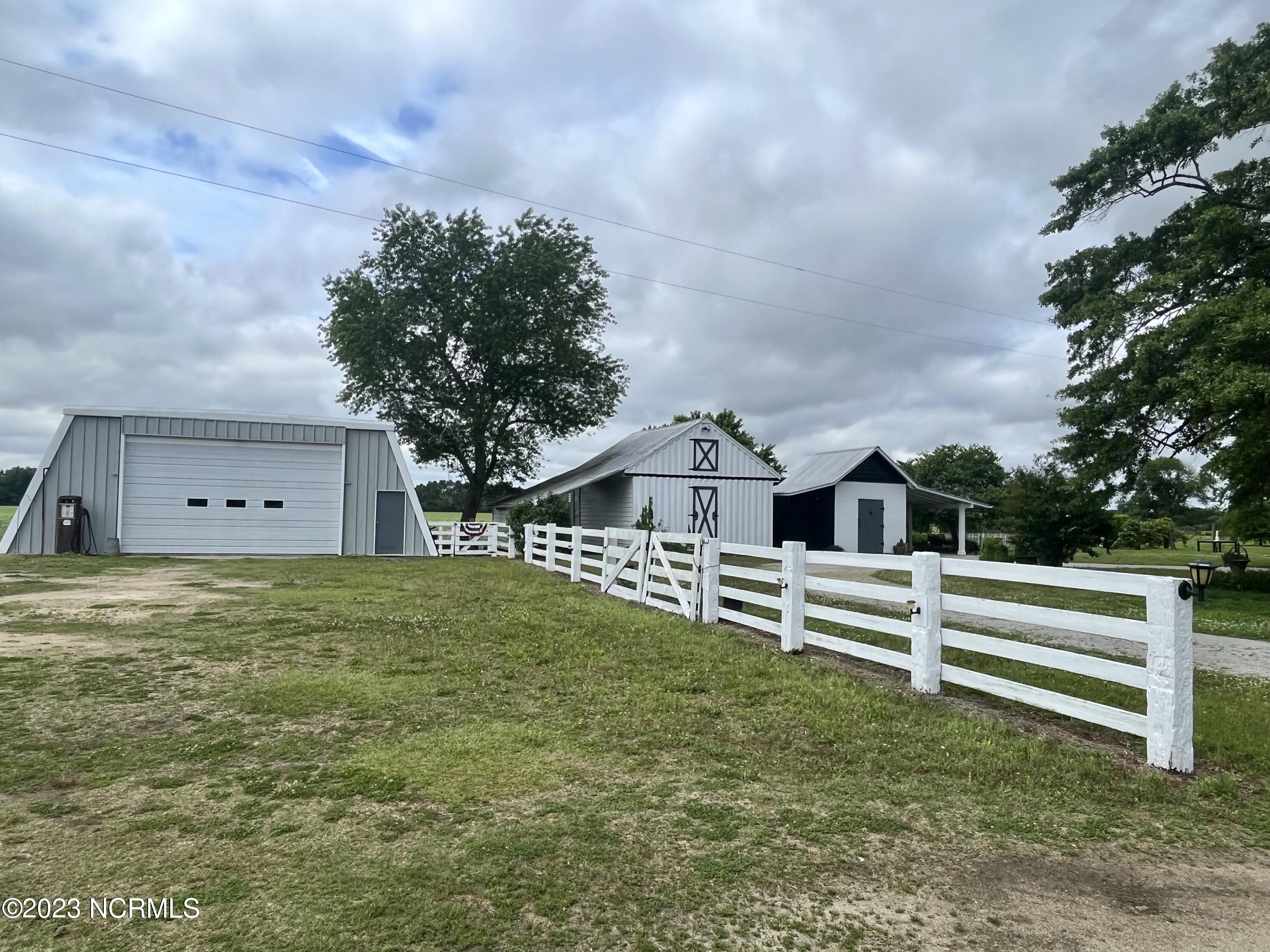 142 Drewery Road Como, NC 27818 - Photo 95 of 113 from the driveway a large workshop, the historic post office and a smokehouse