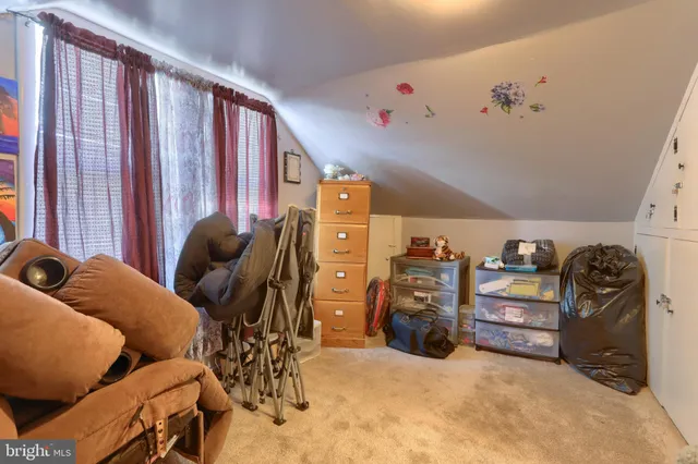 a bedroom with a bed and a chair in it