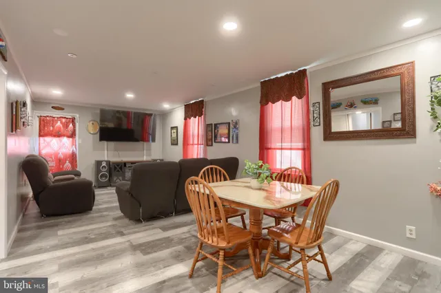 a kitchen with refrigerator a sink and chairs