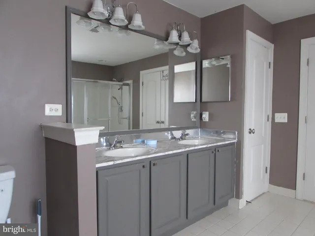 a bathroom with a granite countertop sink a toilet and bathtub