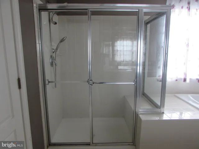 a bath tub sitting in a bathroom next to a window