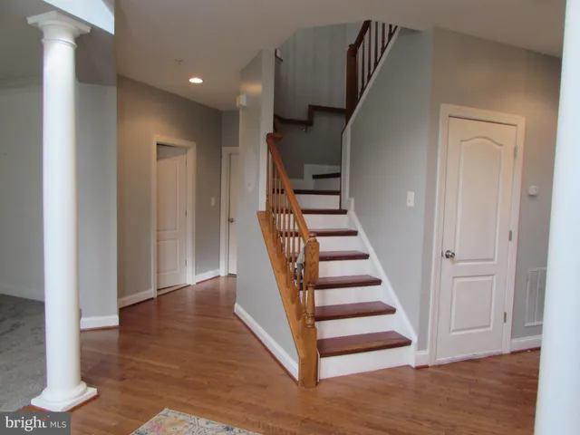 a view of entryway with wooden floor and stairs