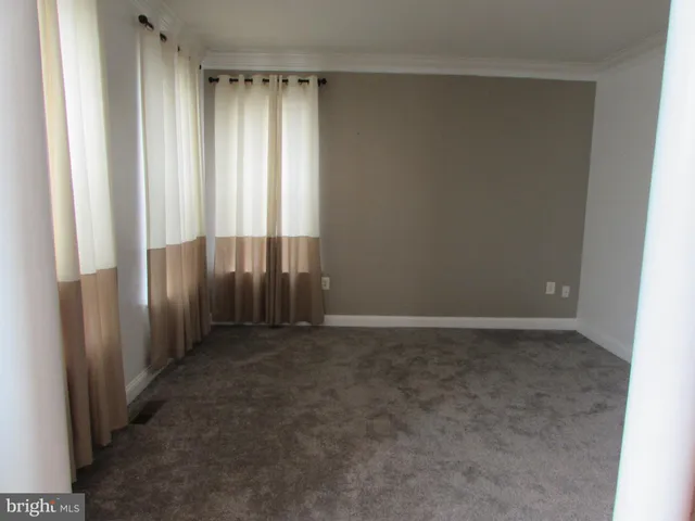 a view of a room with a chandelier fan