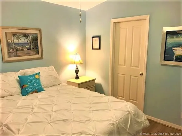 a bedroom with a bed and a painting on the wall