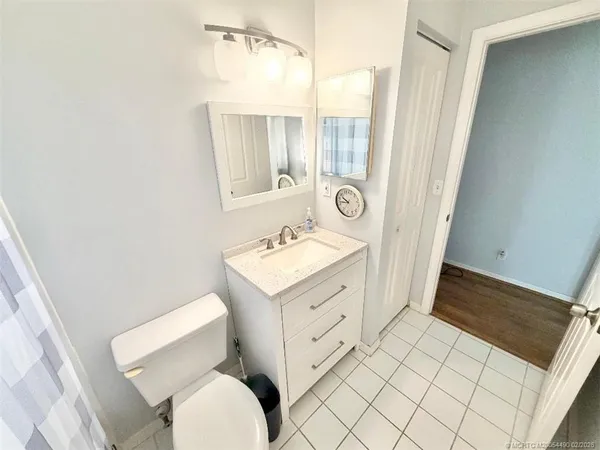 a bathroom with a sink mirror vanity and toilet