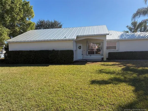 a front view of a house with yard