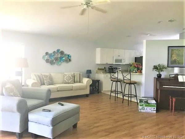 a living room with furniture and kitchen view