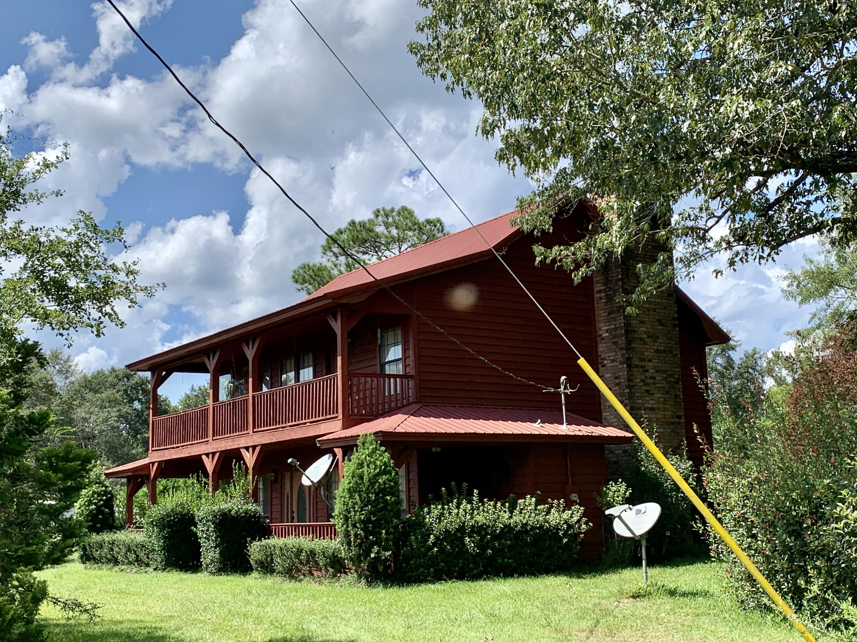 7996 Red Barrow Road Baker, FL 32531 - Photo 1 of 1 a front view of house with yard and green space