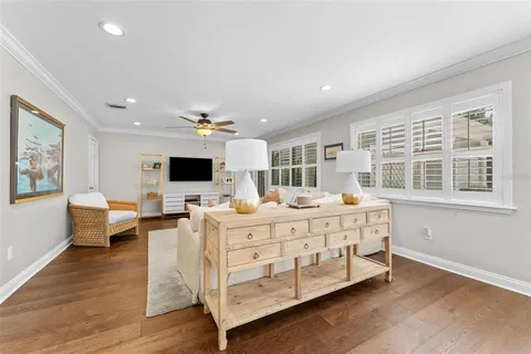 a large bedroom with a bed and a flat screen tv