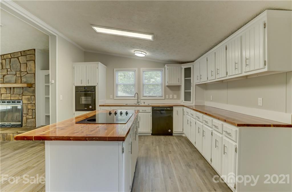179 Davidson Road Clover, SC 29710 - Photo 11 of 31 a kitchen with granite countertop a sink a counter top space stainless steel appliances and cabinets