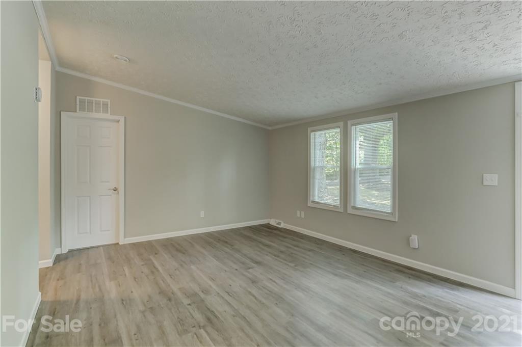 179 Davidson Road Clover, SC 29710 - Photo 5 of 31 an empty room with wooden floor and windows